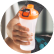 An athletic man in headphones listening to music and holding a pre-workout drink