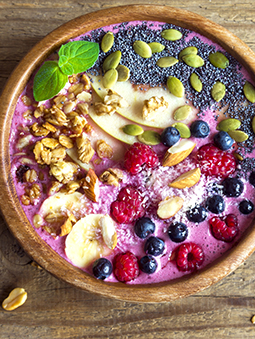 An acai bowl with fruit and nuts