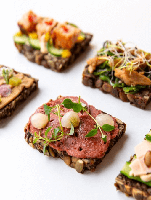 A group of open-faced sandwiches with different toppings